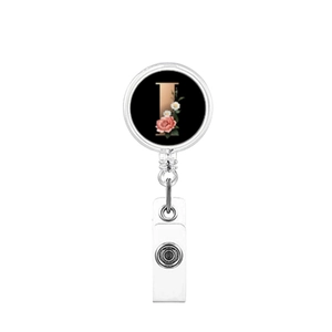 Detail of retractable badge holder with letter I and floral rose pattern on black base