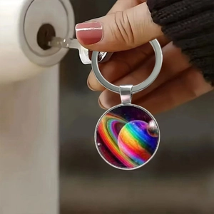 Detailed shot of a galaxy crystal keychain featuring a colorful planet design in use
