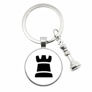 Detailed silver keychain with chess king charm and rook emblem on white background