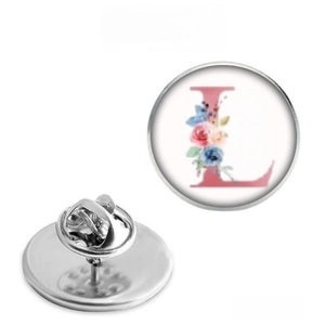 Macro detail of 25mm stainless steel floral letter L brooch with clutch pin back