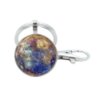 Silver metal keychain with a cosmic nebula galaxy pendant and spring hook closure