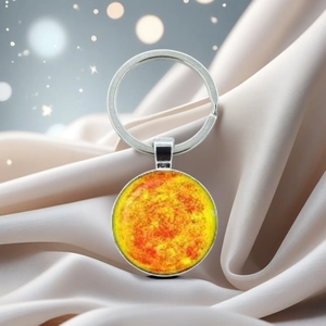 Solar system sun crystal glass keychain with silver metal ring on silk background