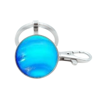 Detail view of Neptune solar system glass keychain with silver metal clip and ring