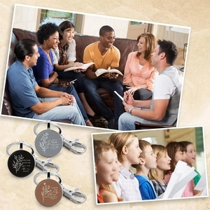 Detail view of round metal keychains with Bible verses in silver, black and bronze tones