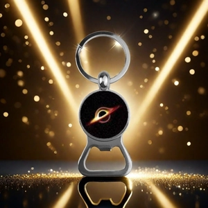 Close-up of silver solar system bottle opener keychain featuring a black hole cosmic design