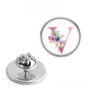 Detailed view showing the front floral letter V and the metal butterfly clutch back pin