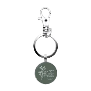 Silver metal inspirational keychain with green glass pendant and flower motifs