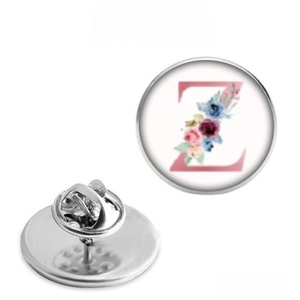 Detail view showing floral letter Z badge with stainless steel butterfly clutch pin back