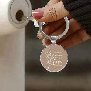Religious keychain with bible verse 1 Corinthians 16:14 being used on a door lock