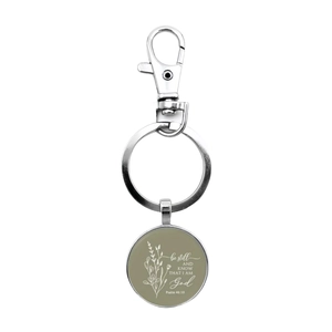 Macro view of silver glass key ring with Psalm 46:10 religious inspirational quote