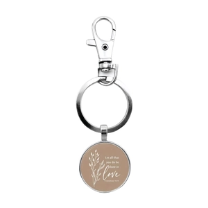 Detail of silver inspirational glass dome keychain with 1 Corinthians 16:14 bible verse