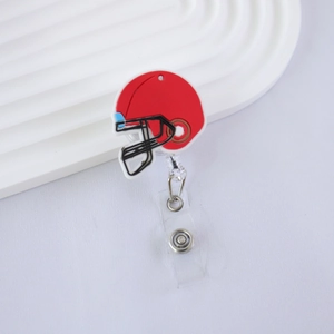 Detail of red football helmet retractable badge reel on white textured surface