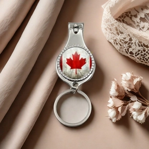 Silver stainless steel nail clipper keychain with red Canada maple leaf flag design