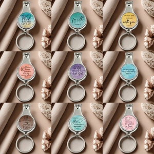 Set of 9 metal nail clipper keychains with colorful watercolor designs and Bible quotes