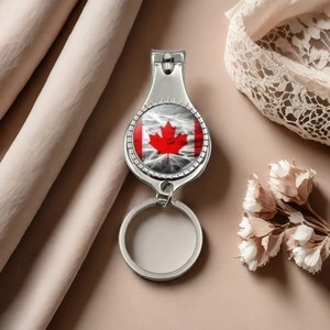 Detail of silver stainless steel nail clipper with Canadian flag maple leaf design