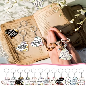 Acrylic heart keychains with Spanish religious verses and floral patterns on vintage book