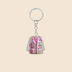 Macro view of nurse uniform acrylic charm with pink stethoscope and medical tools