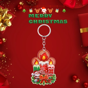 Close-up of 2D acrylic Christmas keychain featuring Santa Claus and Merry Christmas text