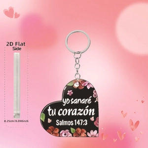 Detail view of 2D acrylic heart keychain with Spanish scripture and floral pattern