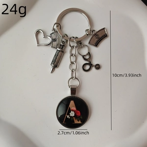 Doctor stethoscope keychain with heart, syringe, nurse hat, and gold letter A charm