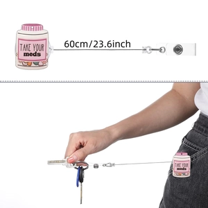 Detail showing retractable badge holder with Take Your Meds medicine bottle design