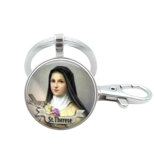 Detailed view of silver St. Therese religious pendant keychain with spring hook