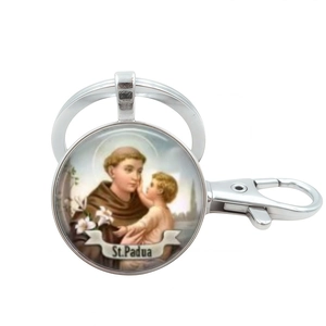Silver St. Padua religious glass dome keychain with saint and child illustration