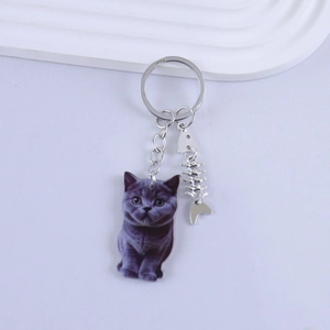 Japanese style resin cat keychain with a blue British Shorthair and silver fishbone charm