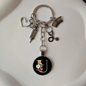 Detailed silver stethoscope keychain with medical charms and floral letter U pendant
