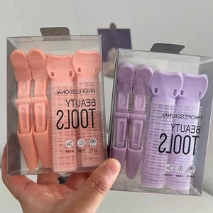 Set di clip volumizzanti e bigodini rosa e viola per dare volume alle radici dei capelli