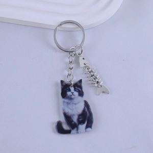 Detail of creative resin cat keychain with silver metal keyring and fishbone charm