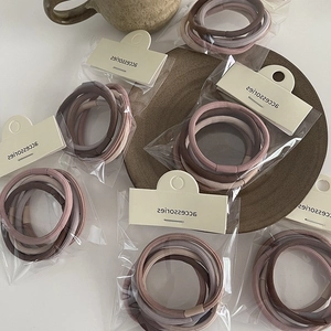Detailed view of high-elasticity hair ties in earth-toned Morandi colors and ribbed knit texture