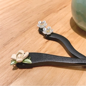 Elegant black wood flower hair pins in S-curve design with white magnolia and leaf