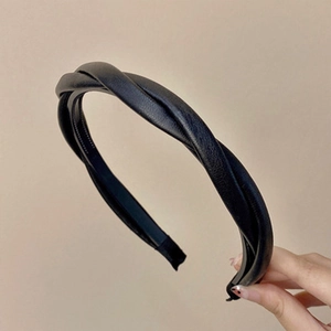Detail of black twisted faux leather headband showing non-slip teeth and texture