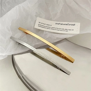 Detailansicht minimalistischer Haarklammern in Gold und Silber mit gebürstetem Metall