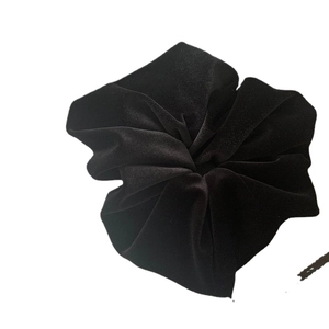 Large black velvet scrunchie hair tie with soft pleated design for elegant hairstyles