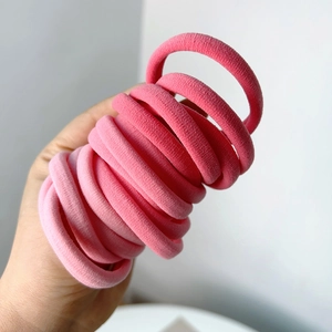 High elasticity seamless pink gradient hair ties held in hand for daily hairstyles