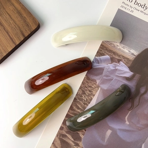 Set of four French acetate curved hair clips in vintage earth tones and glossy finish