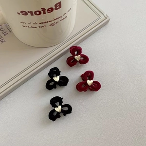 Mini velvet hair clips set in black and burgundy with gold heart detail in a four-pack
