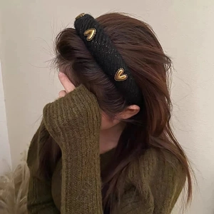 Padded black tweed headband with gold heart accents for a retro high-top volume look