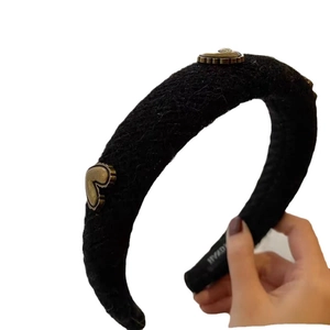 Padded black tweed headband with vintage gold heart charms for an elegant retro style
