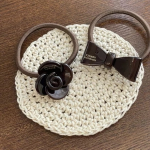 Deep brown elastic hair tie set featuring resin flower and bow with gold lettering