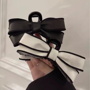 Elegant large bow hair claw clip set in matte black and white leather finish