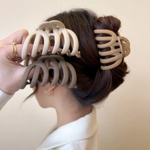 Set of large brown and cream matte hair claws shown on elegant updo hairstyle