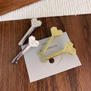Unique heart-shaped key hair clips in gold and silver metal with romantic engravings