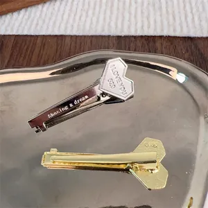 Creative silver and gold key-shaped hair clips with I LOVE YOU engraving on a metal tray