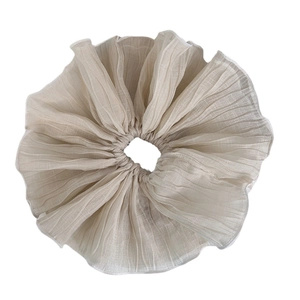 Pleated oversized hair scrunchie in beige mesh fabric with fine radial folds