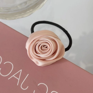 Elegant 3D peach satin rose hair tie with elastic band on a pink gift box display