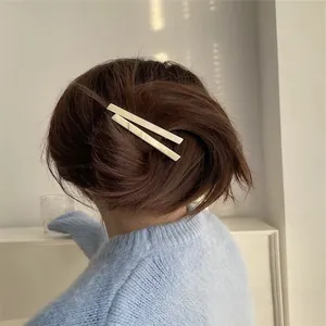 French style matte cream hair clips set worn on wavy brown hair for a soft look