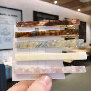 Set of five tortoiseshell and marble acetate rectangular hair clips on display card